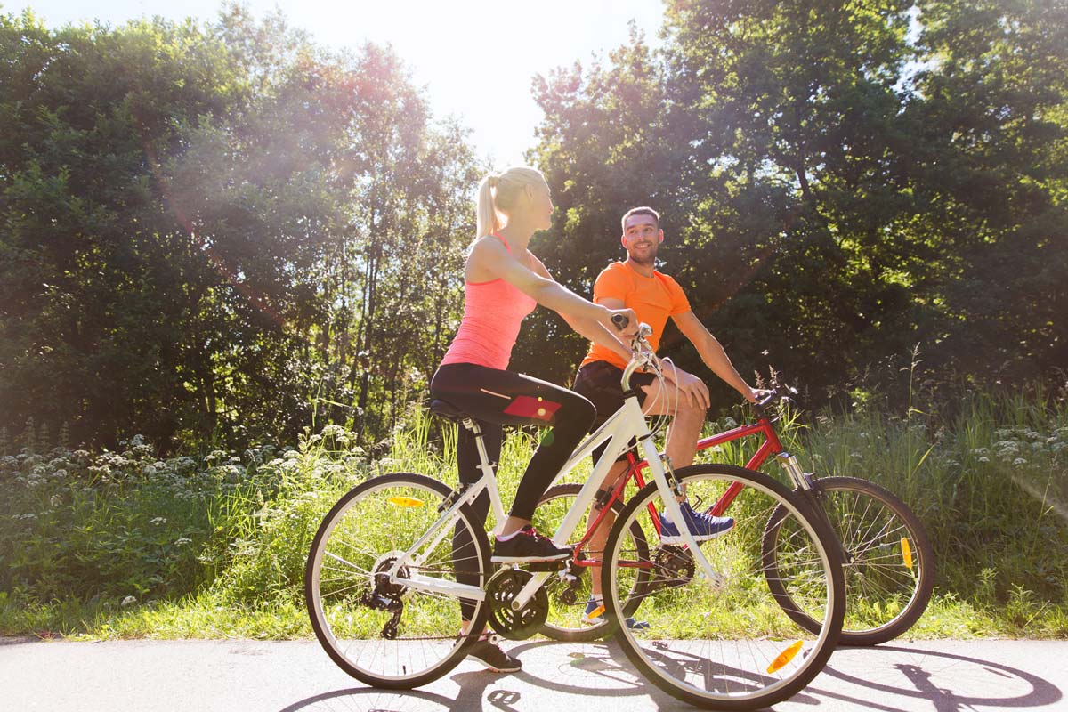 Cyclists riding on a sunny path