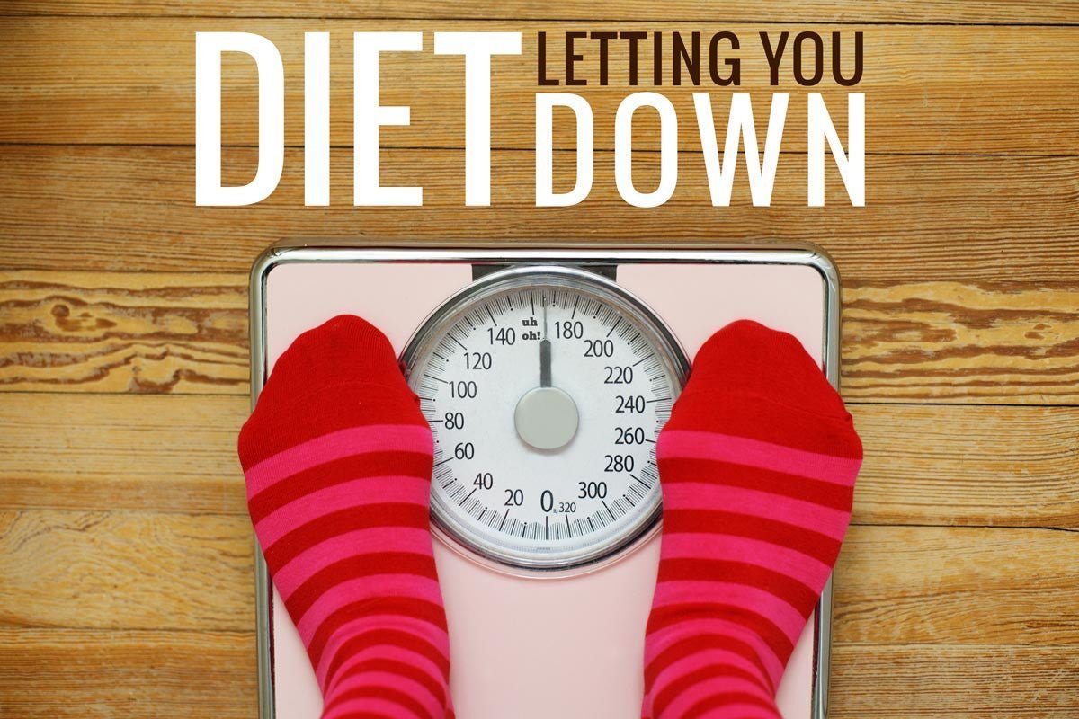 Feet on bathroom scales beside diet advice