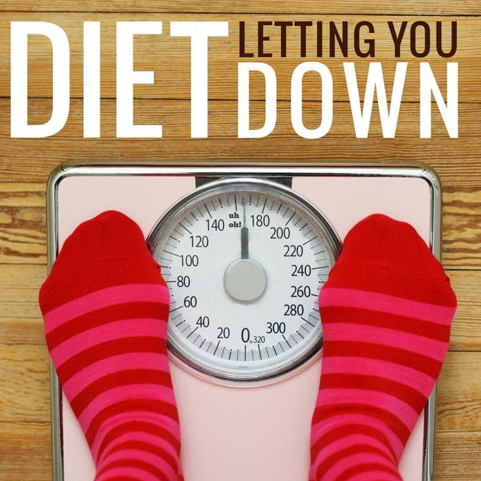 Feet on bathroom scales beside diet advice